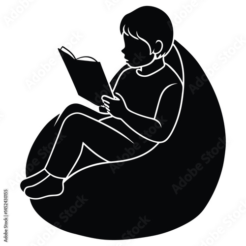 Child engrossed in reading a book while comfortably seated in a beanbag chair