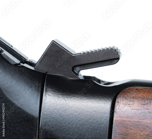 Close up of the hammer cocked on a lever action rifle with wood stock