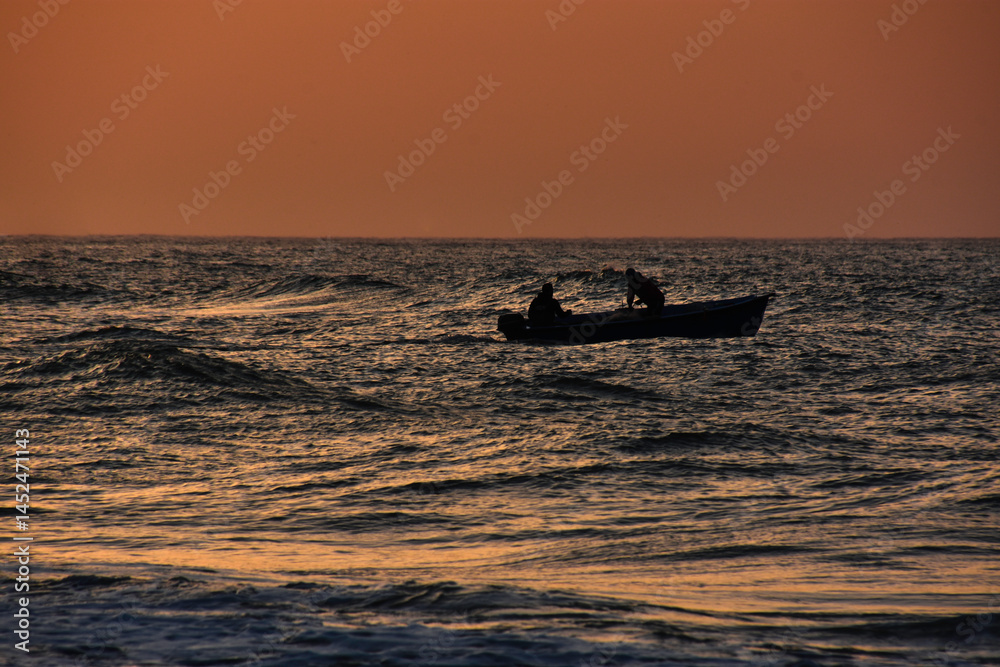 Fototapeta premium Wave sea beach and sunset sky abstract background. Nature and summer concept. Summer background, warm beach view with sunset, calm waves and sun rays reflecting on sea surface. vacation concept.