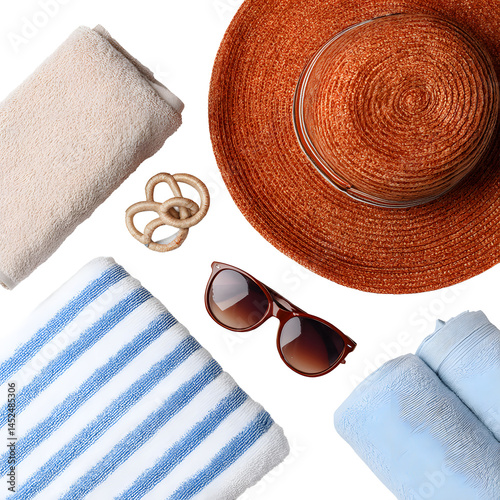 Vacation essentials: hat, towels, sunglasses, decorative knot on black backdrop.