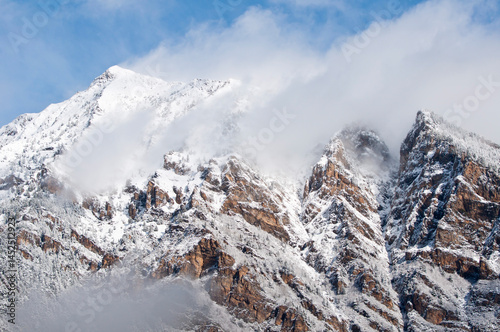 Rocky hillside with scattered trees and snow