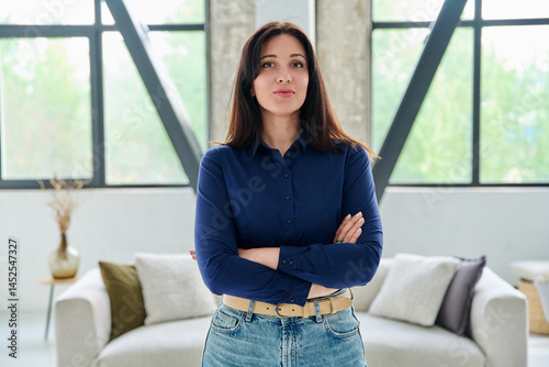 Obraz na płótnie Portrait of beautiful young confident woman in office with couch w salonie