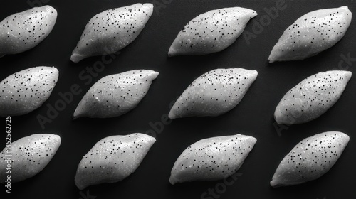 A visually striking arrangement of textured lemon-shaped objects on a dark background