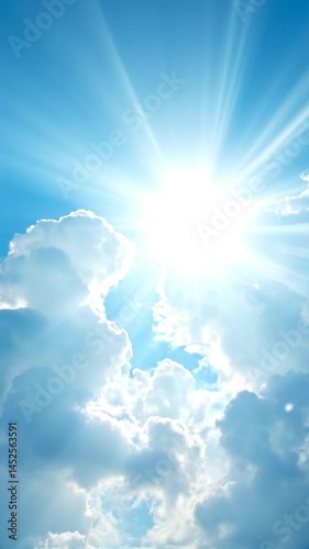 Low angle time lapse bright sun on blue summer sky with moving fluffy clouds, sun shining sunbeams, white cumulus clouds on sunshine day