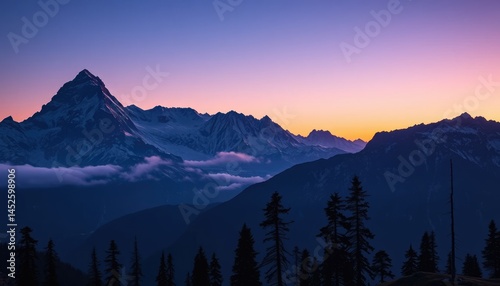 dramatic mountain range under a deep blue-purple pre-dawn sky
