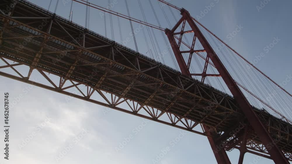 Airplane flying over the 25 de abril bridge, a suspension bridge connecting the city of lisbon, capital of portugal, to the municipality of almada on the left bank of the tagus river Airplane flying over the 25 de abril bridge, a suspension bridge connecting the city of lisbon, capital of portugal, to the municipality of almada on the left bank of the tagus river