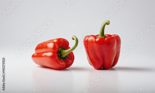 Obraz na płótnie Two bright red peppers sit side by side w salonie