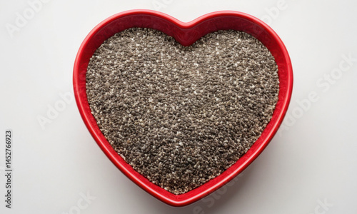 Obraz na płótnie A red heart-shaped bowl filled with chia seeds w salonie