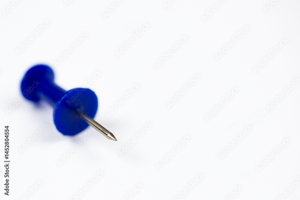 Close-up of a colored pin on a white background, isolate with space for text Close-up of a colored pin on a white background, isolate with space for text