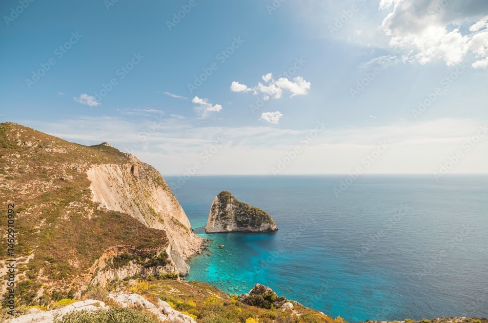 Fototapeta premium Experience the enchanting beauty of Zakynthos, where stunning cliffs meet crystal-clear waters. Enjoy vibrant beaches and traditional villages under the radiant summer sun