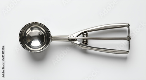 Ice cream scoop with steel head and ergonomic handle, laid flat on white