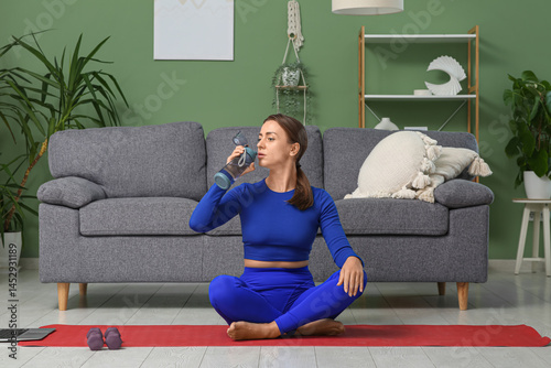 Sporty woman drinking water...