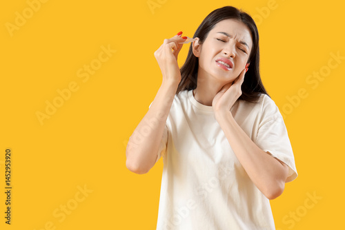 Young woman with otitis usi...