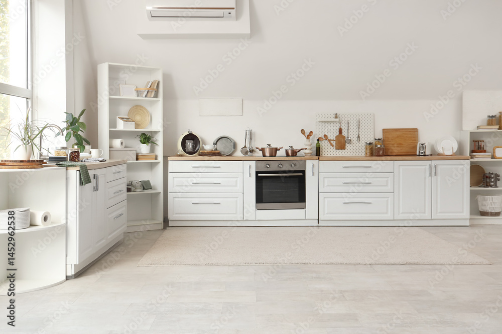Fototapeta premium Interior of kitchen with white counters, shelf units and utensils