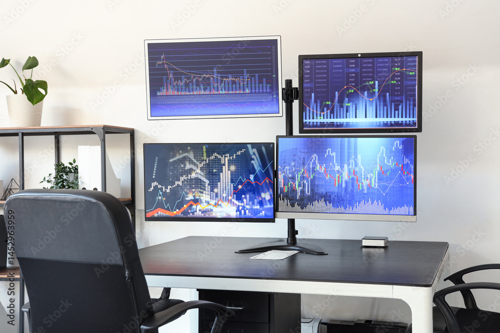Naklejka premium Computer monitors with stock data on trader's table in office