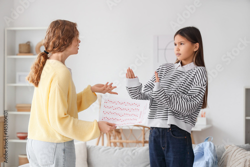Mother scolding her daughte...