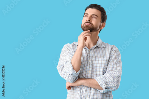 Thoughtful young man lookin...