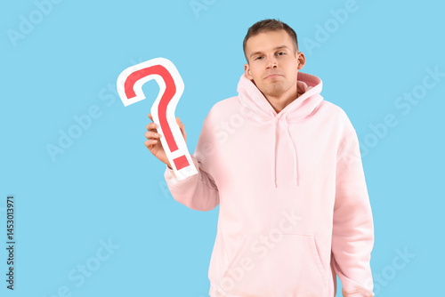 Young man with paper questi...