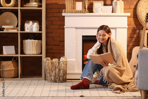 Young woman with warm plaid...