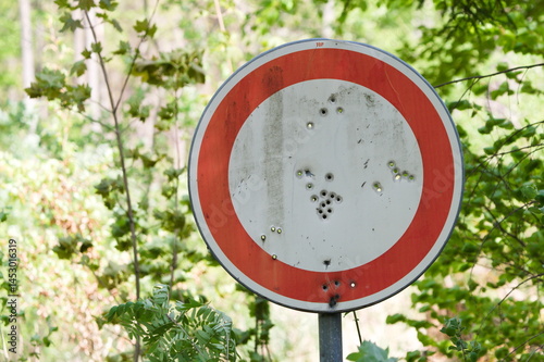 Bullet holes on road traffic sign in Czech republic. 