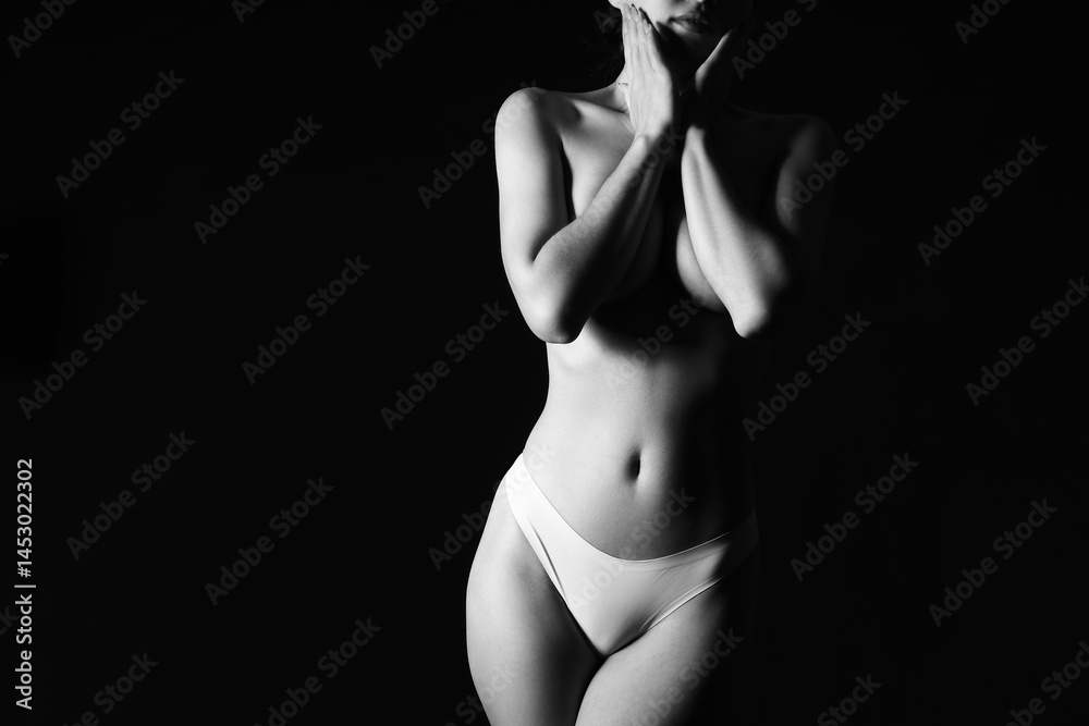 Naklejka premium Silhouette of attractive young woman on dark background