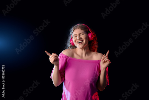 Happy young woman in headph...