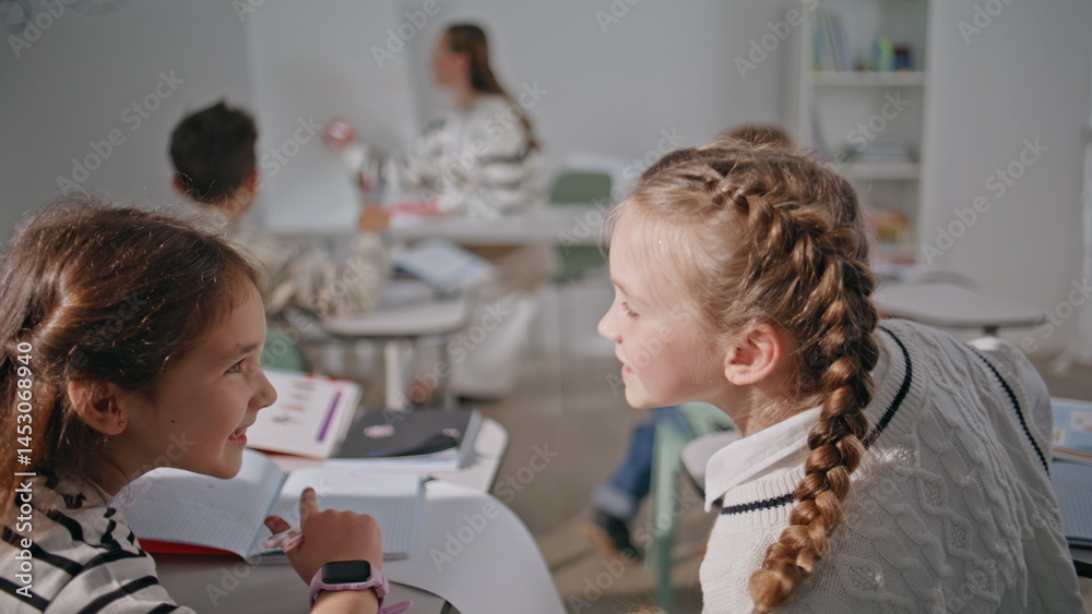 Small school friends talking at lesson closeup. Funny cute girls communicating