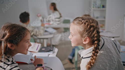 Obraz na płótnie Small school friends talking at lesson closeup. Funny cute girls communicating w salonie