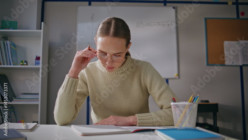 Obraz na płótnie Attentive lady working school light day closeup. Woman in glasses putting marks w salonie