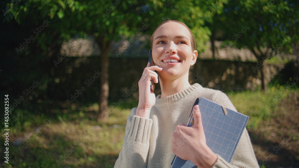 Smiling model calling street sunlight park closeup. Happy woman speaking phone