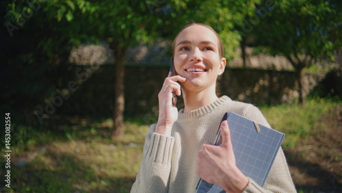 Obraz na płótnie Smiling model calling street sunlight park closeup. Happy woman speaking phone w salonie