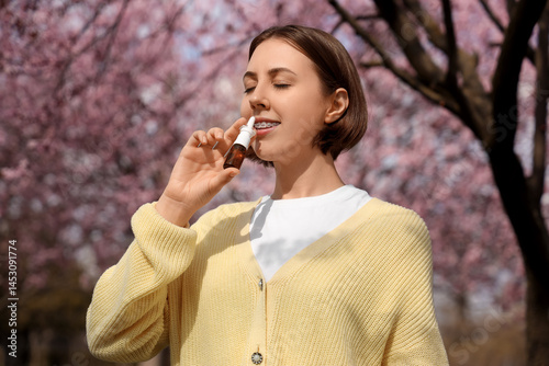 Allergic young woman using ...