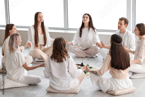 Group of people meditating ...