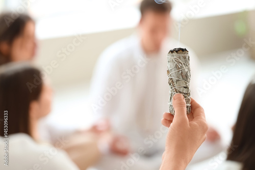 Woman cleansing space with ...