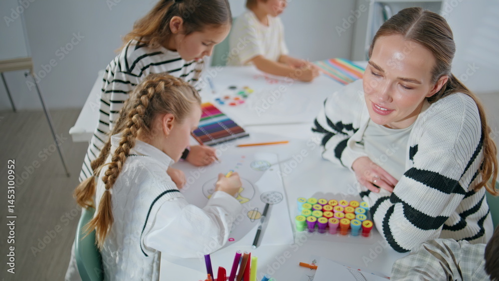 Painter lady teaching children drawing workshop closeup. Pupil teacher creating