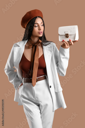 Stylish young woman in whit...