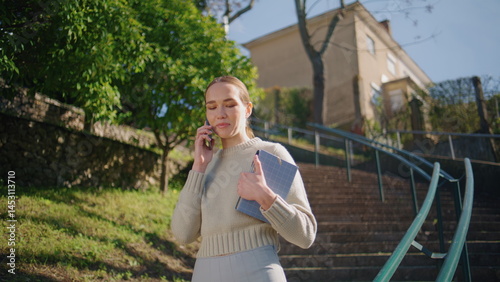 Obraz na płótnie Smiling woman talking mobile phone call sharing good news at sunny park closeup w salonie