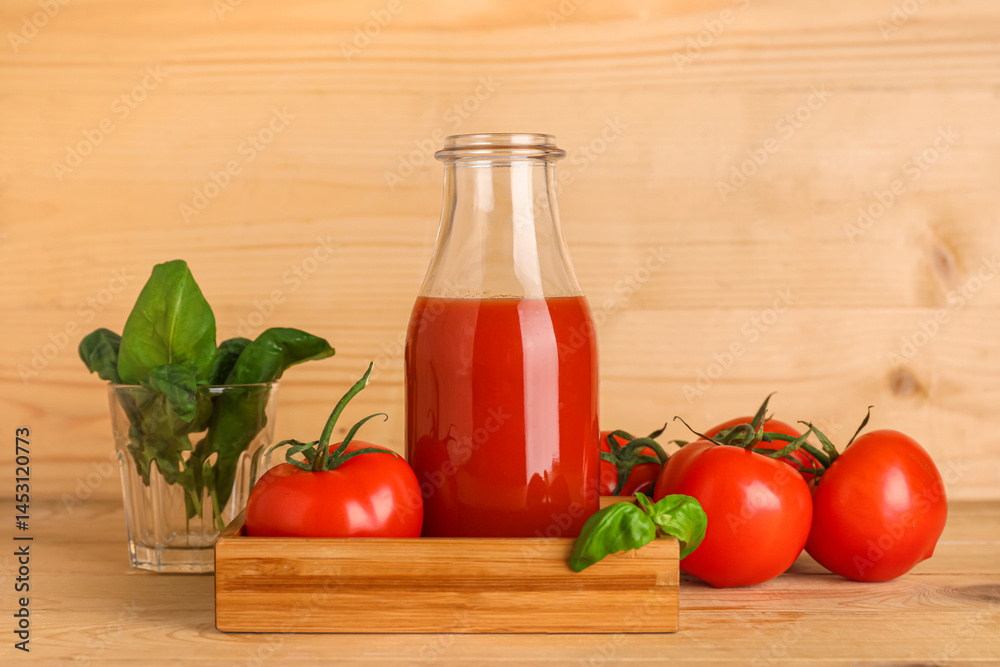 Bottle of fresh tomato juice with basil and vegetables on wooden background Bottle of fresh tomato juice with basil and vegetables on wooden background