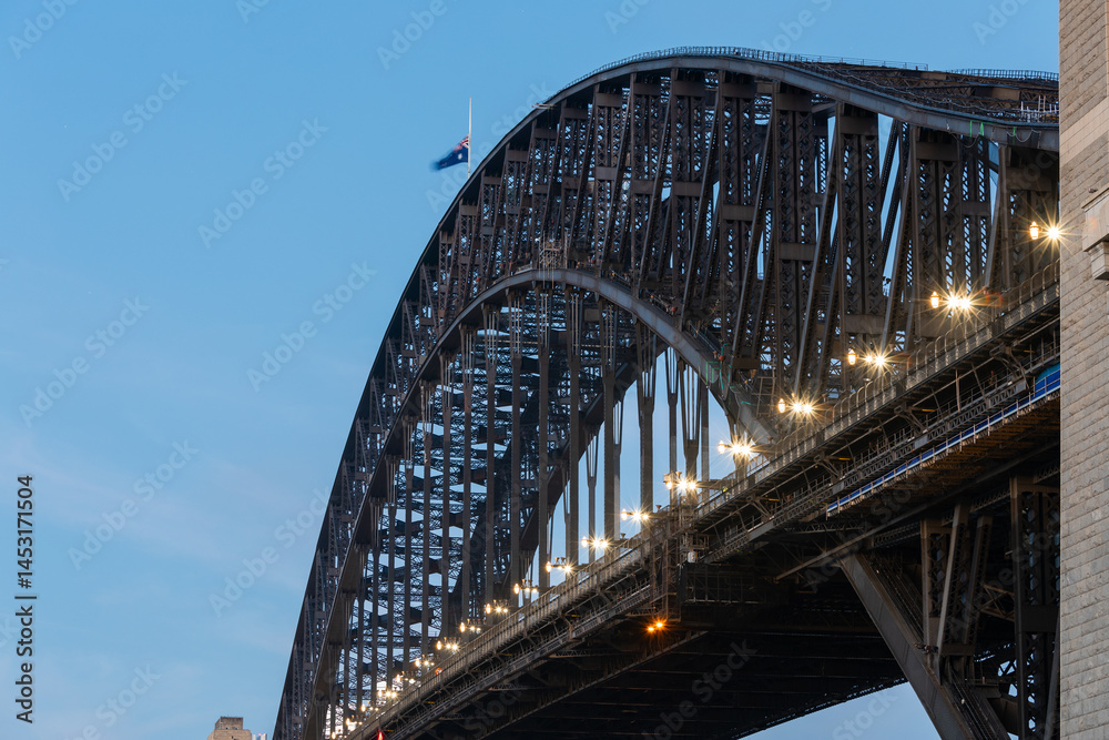Naklejka premium Close-up view of Sydney Harbour Bridge with blue dusk sky.