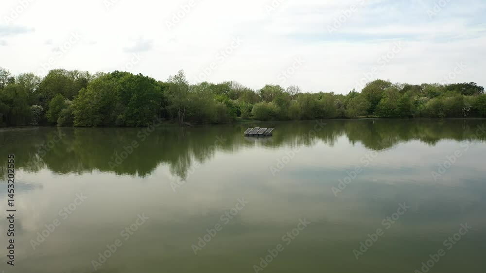 This video features a tranquil lake with dense, lush green trees lining its banks. This video features a tranquil lake with dense, lush green trees lining its banks.