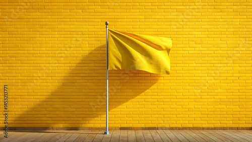 Yellow flag waving in front of a yellow brick wall on bright day