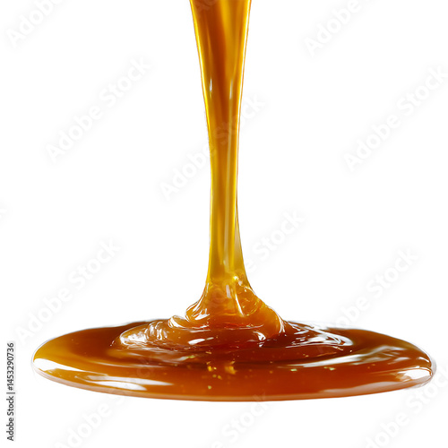 Close up of caramel sauce pouring down onto a surface against a black background studio shot