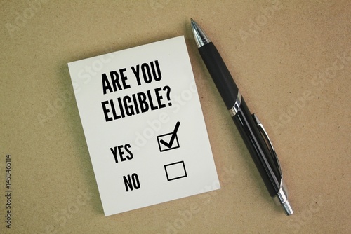Pen and paper with question word Are you eligible? the concept of choice. choose yes
