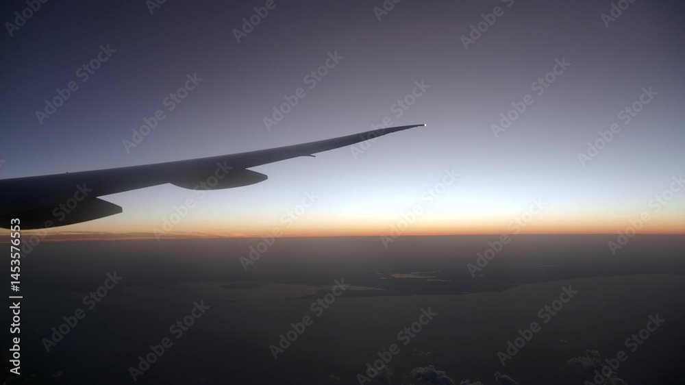 Sunset view from airplane wing during twilight flight