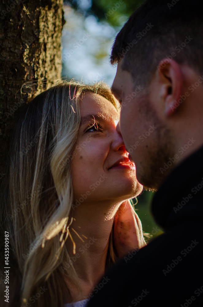 Fototapeta premium Young man and woman. Beautiful couple walking in the park. Romantic walk, photo shoot. Blonde and brunette