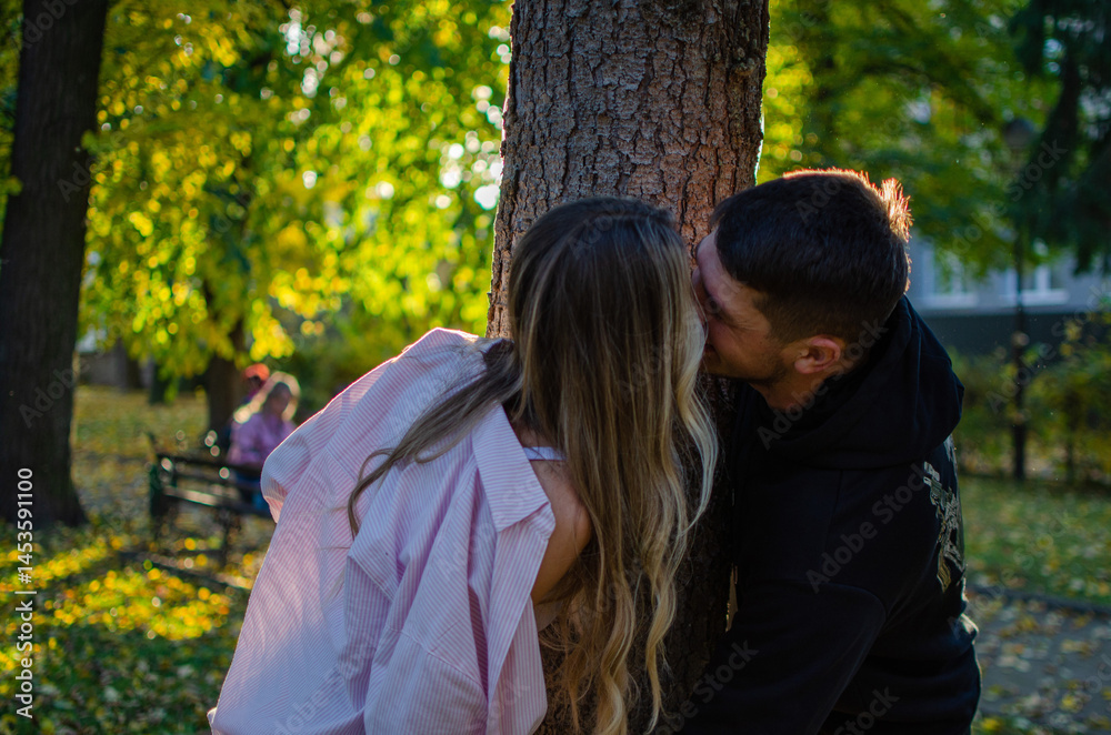 Fototapeta premium Young man and woman. Beautiful couple walking in the park. Romantic walk, photo shoot. Blonde and brunette