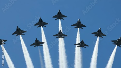Spectators watch as fighter jets fly in formation, creating impressive vapor trails