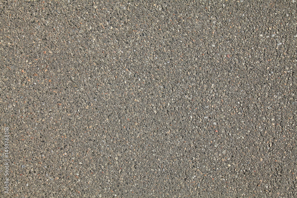 An old, faded asphalt surface, background. Detailed texture of the bitumen with abstract pattern. Yellowed stone backdrop. Road foundation, based on crushed stone and resin. Textured road backdrop An old, faded asphalt surface, background. Detailed texture of the bitumen with abstract pattern. Yellowed stone backdrop. Road foundation, based on crushed stone and resin. Textured road backdrop