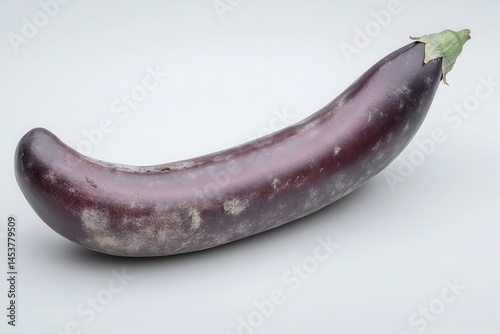 Wallpaper Mural Fresh, glossy eggplant resting on a smooth surface, showcasing its vibrant color and texture Torontodigital.ca