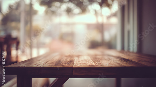 Rustic wooden table with blurred outdoor cafe background at sunset